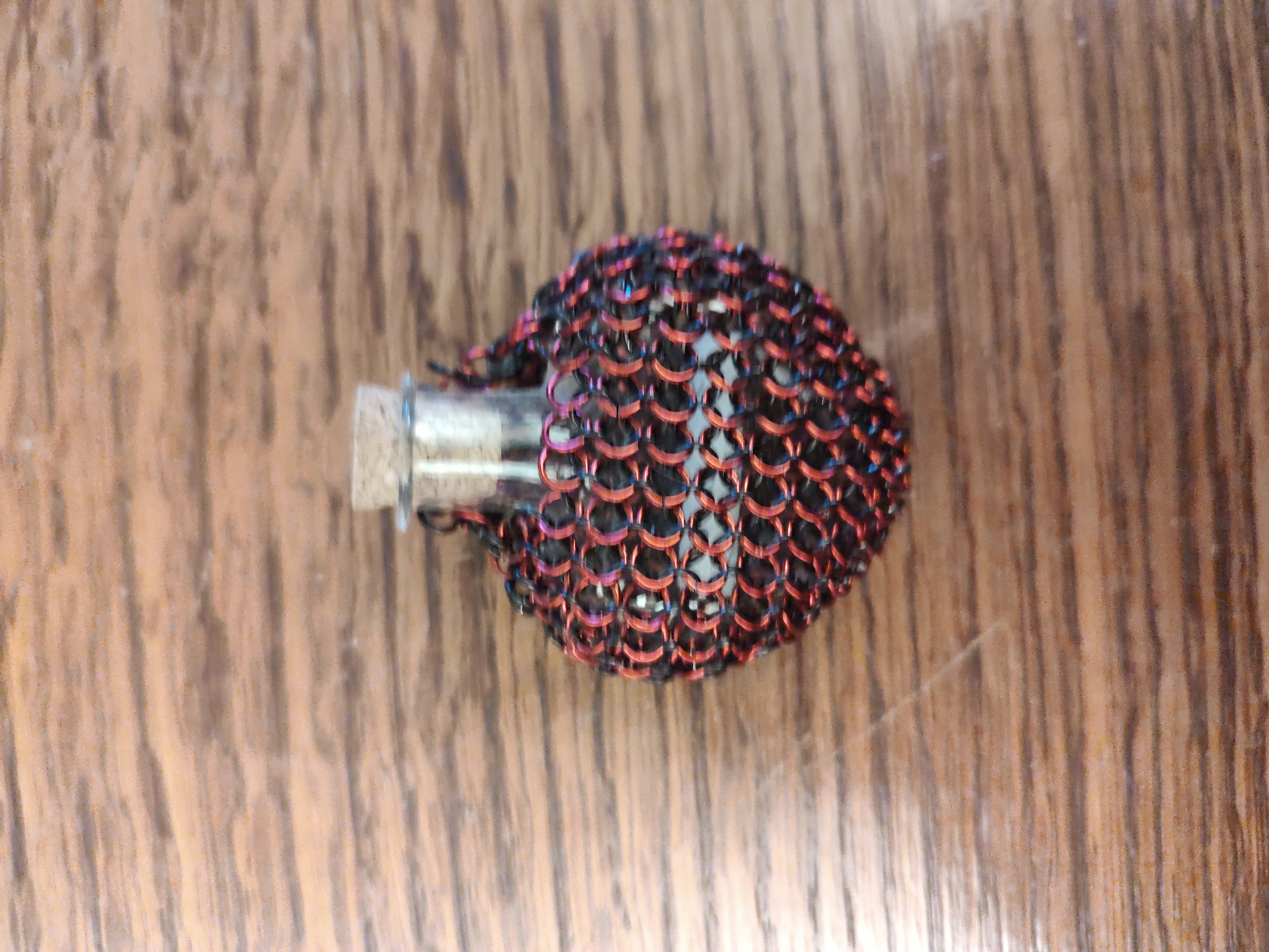 Red and black chainmail heart shaped glass vial